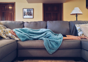 Ways to Sleep Better - woman sleeping on couch 