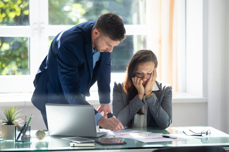 businessman explaining graph  to sad female employee